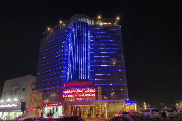 A beautifully lit building facade in Dubai at night